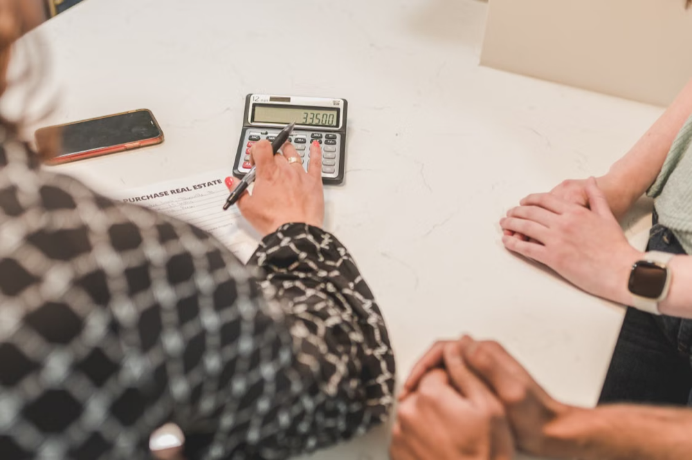 Real estate agent using a calculator