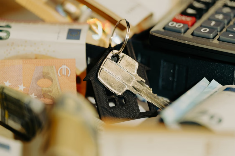 Real estate investment with house key and cash