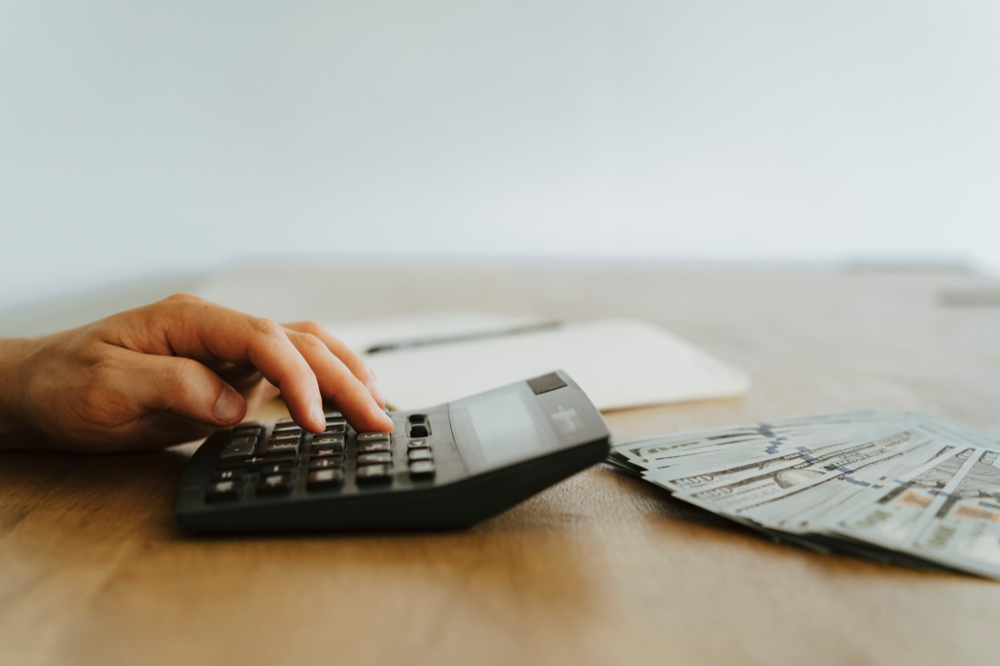 Close up photo of a person using a calculator