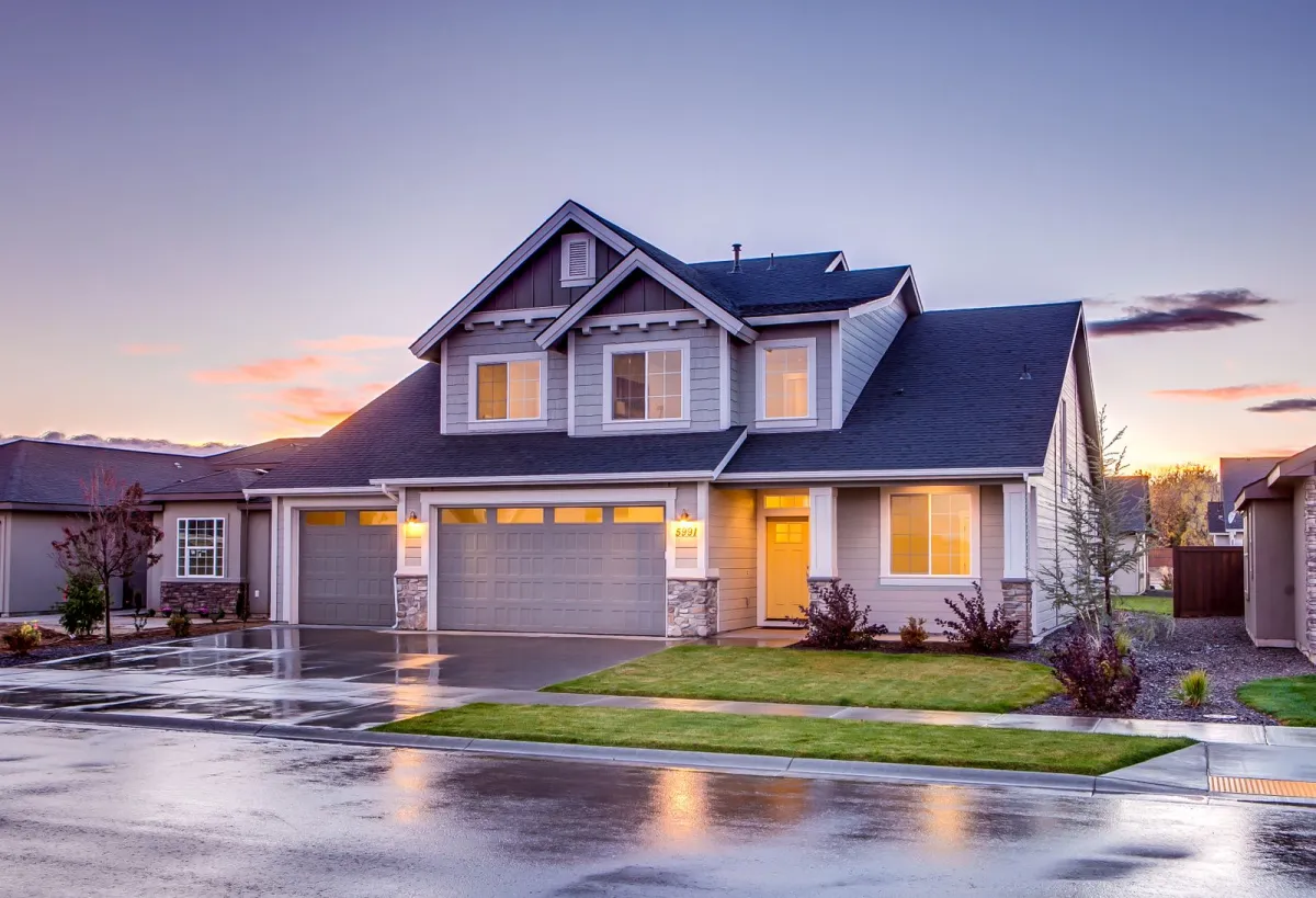 Blue and gray concrete house with attic during twilight.